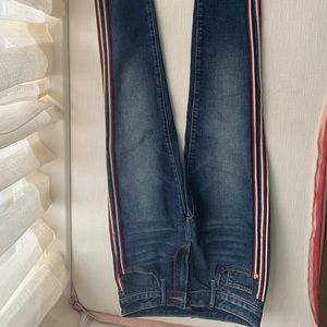 Aqua blue jeans with red and white side stripe,